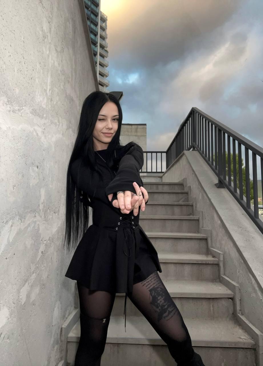 Alt Angel Roxie wearing a black alternative outfit outdoors